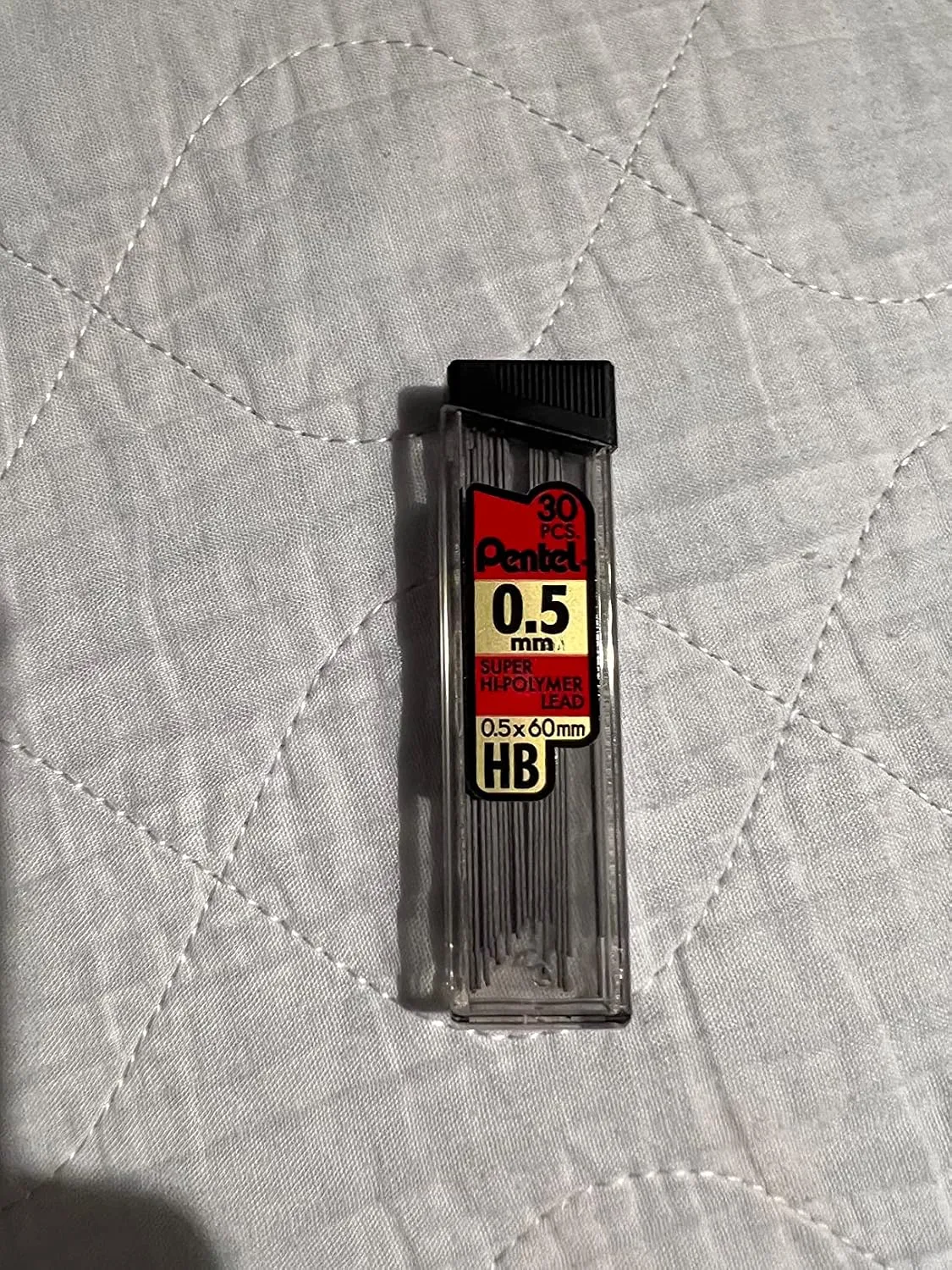 Customer photo showing three mechanical pencil lead sizes lined up for comparison - 0.3mm, 0.5mm, and 0.7mm tips